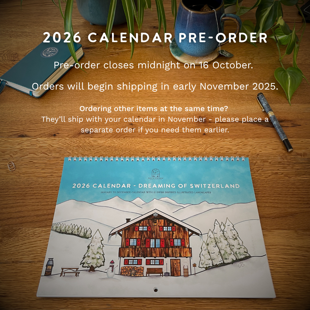 2026 calendar pre-order with a wooden cabin illustration on a table.