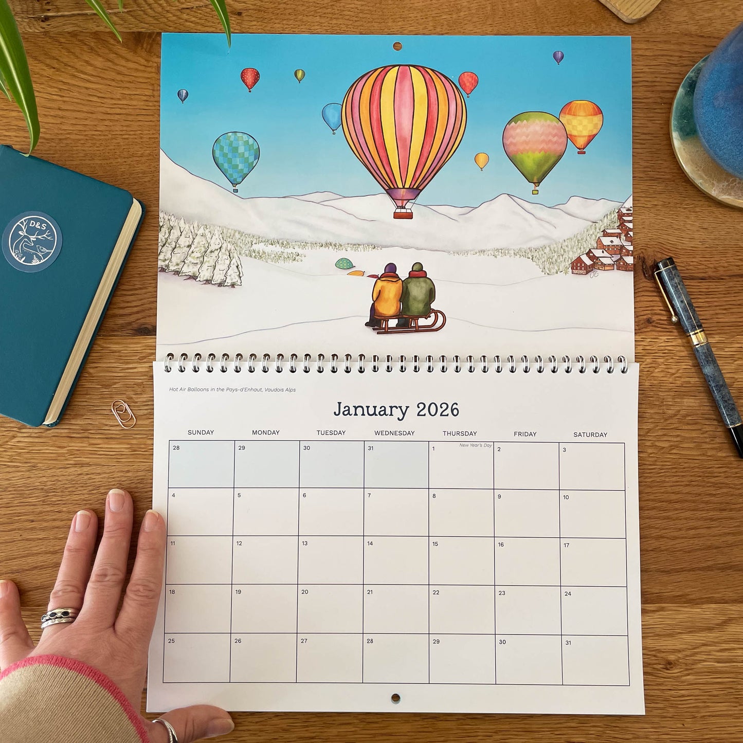 January spread - Hot air balloons over Pays-d’Enhaut above monthly grid with roomy writing boxes.