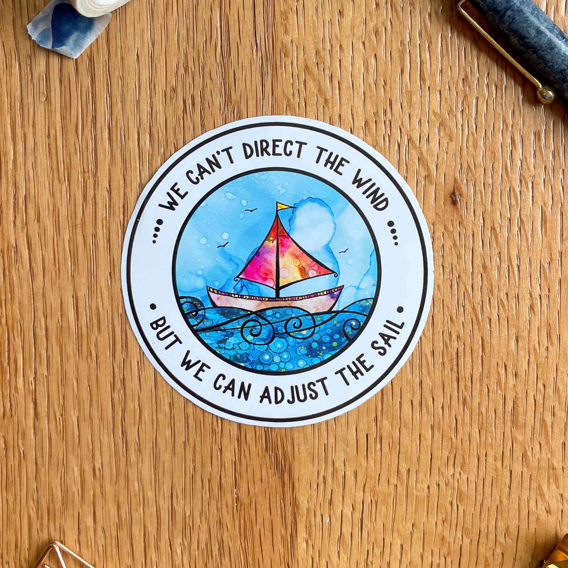 Encouraging sailing boat vinyl sticker with the quote 'We can't direct the wind, but we can adjust the sail' - a reminder to stay motivated on tough days.