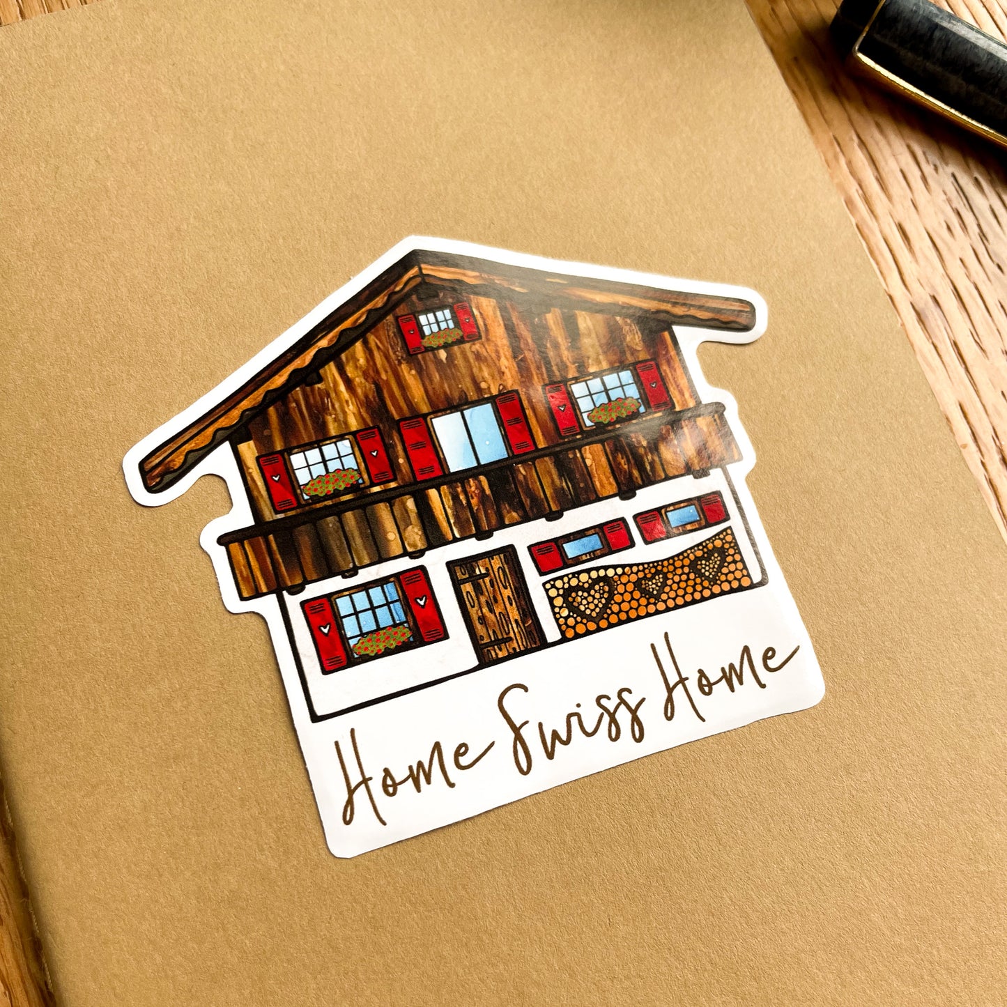 Decorate your belongings with this delightful Swiss Chalet vinyl sticker, bringing the spirit of Switzerland wherever you go.