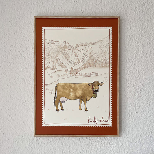 A charming Swiss Brown Cow grazing in the lush green meadows of the Swiss Alps - perfect for nature-loving hikers and outdoor enthusiasts.