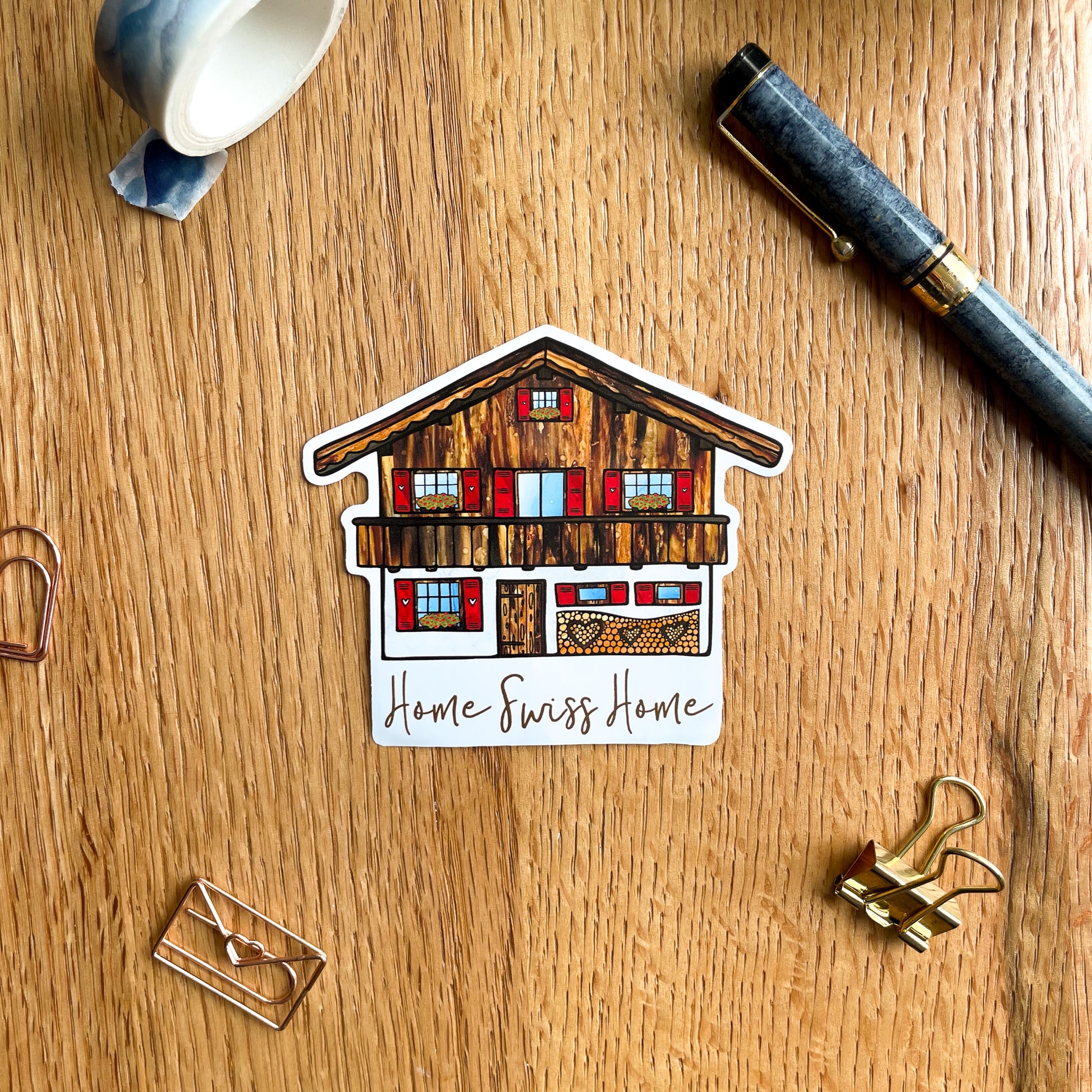 Celebrate the beauty of Switzerland with this eye-catching vinyl sticker, reminiscent of an idyllic Swiss house nestled in the mountains.