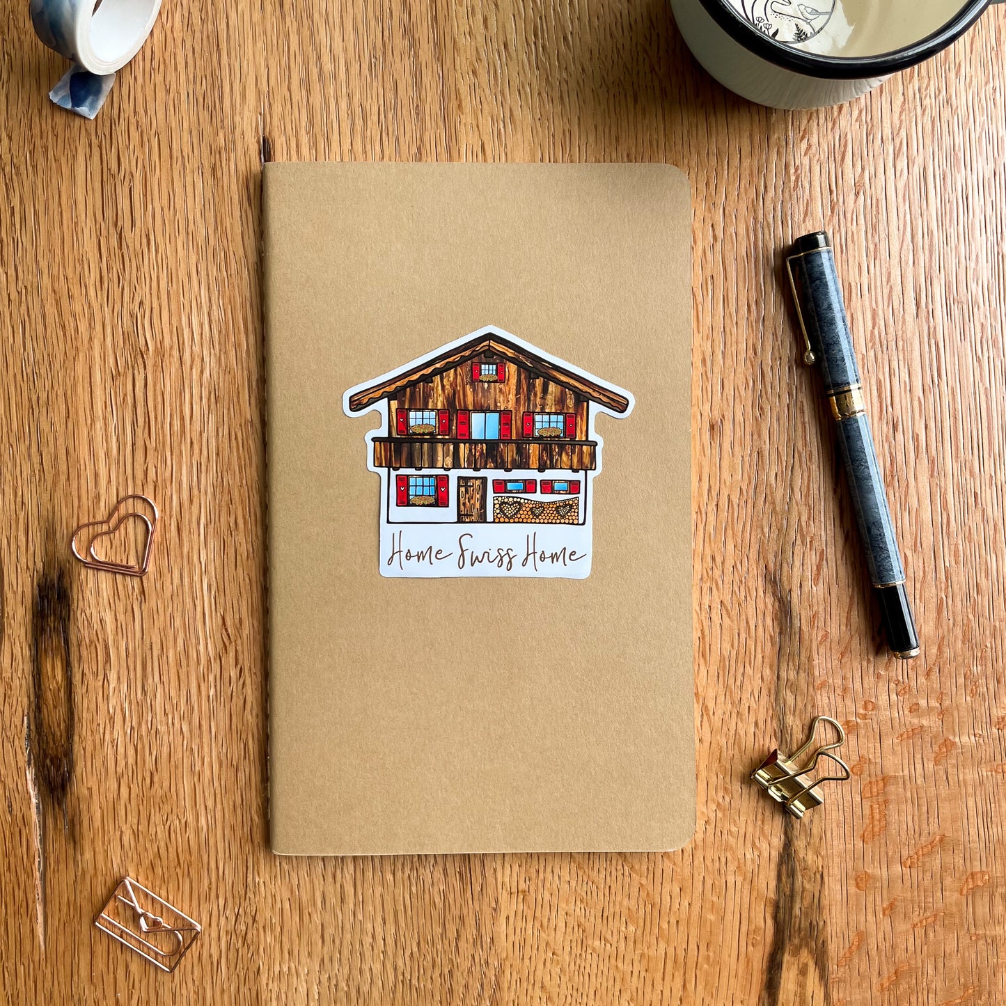 Adorn your travel journal with this lovely vinyl sticker depicting a dreamy Swiss Chalet - the perfect memento from your travels in Switzerland.